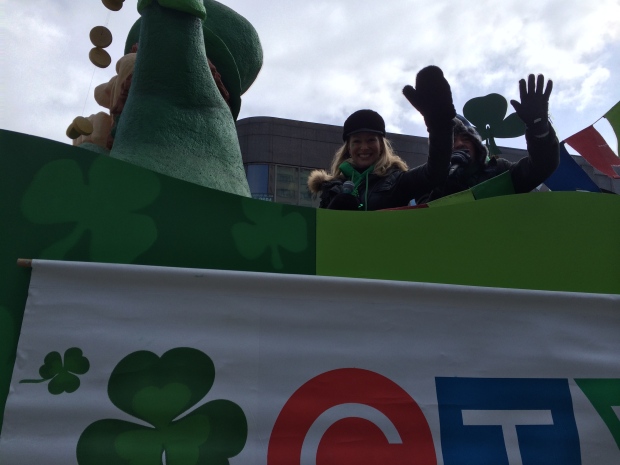 Lori Graham waves from a float at the St. Patrick'