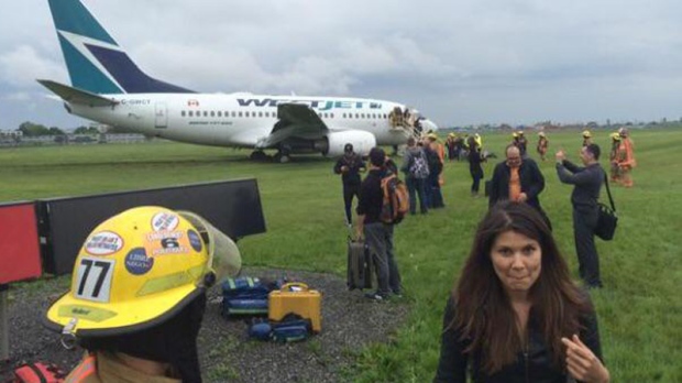Passengers are seen disembarking from the WestJet