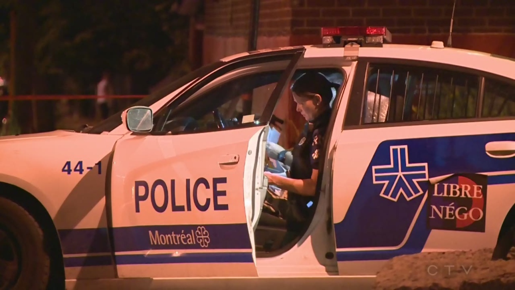 A Montreal police officer in a squad car
