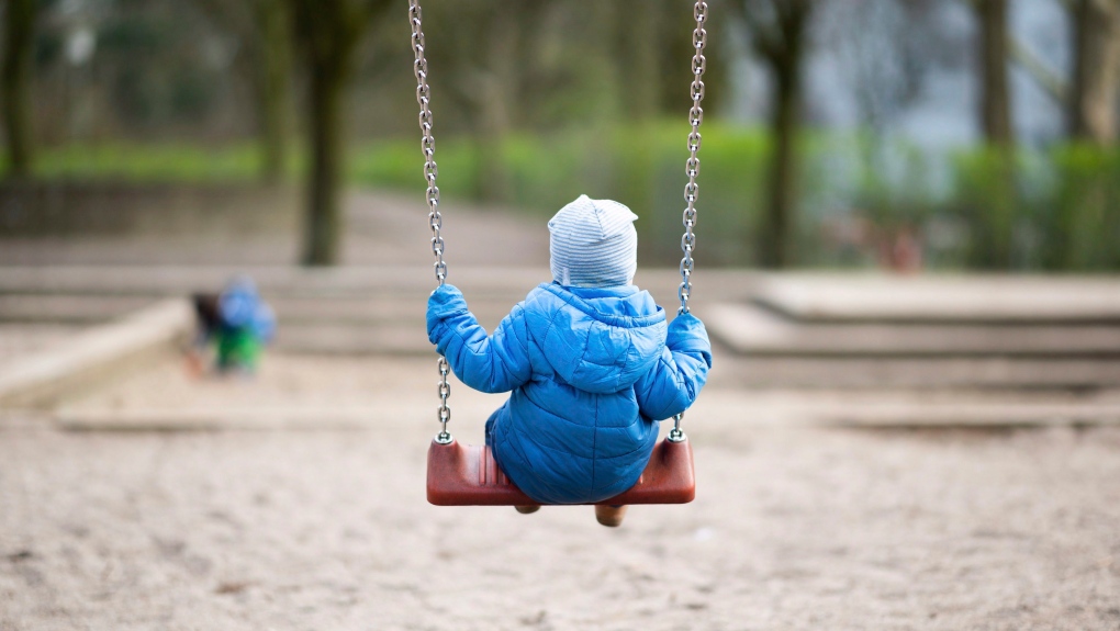 This file photo shows a toddler rocking on a playground in Hamburg, Germany, Tuesday, March 17, 2020. (THE CANADIAN PRESS/dpa via AP, Daniel Reinhardt)