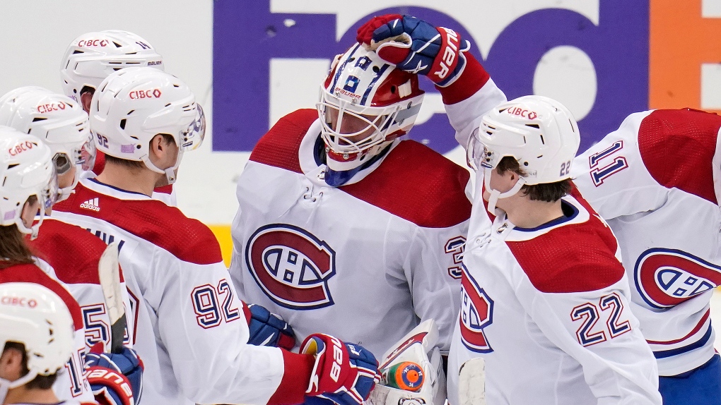 Montreal Canadiens goaltender Jake Allen, center, celebrates with teammates after a win over the Pittsburgh Penguins in an NHL hockey game in Pittsburgh, Saturday, Nov. 27, 2021. (AP Photo/Gene J. Puskar) 