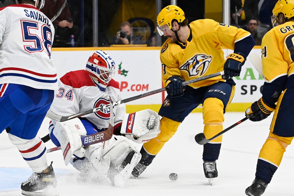 Montreal Canadiens goaltender Jake Allen (34) blocks a shot by Nashville Predators left wing Filip Forsberg (9) during the second period of an NHL hockey game Saturday, Dec. 4, 2021, in Nashville, Tenn. (AP Photo/Mark Zaleski) 