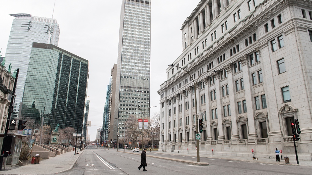 A man crosses an empty street in downtown Montreal, Sunday, April 5, 2020. THE CANADIAN PRESS/Graham Hughes 
