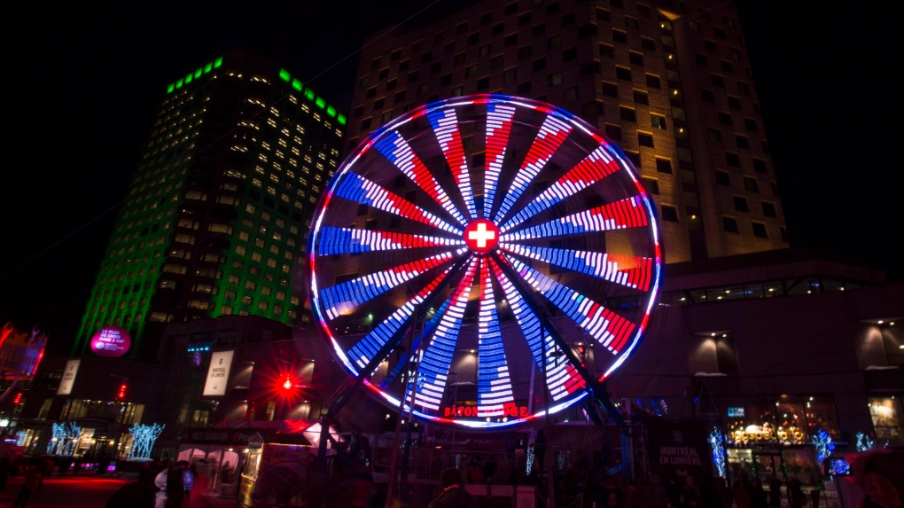 A ferris wheel spins around in downtown Montreal during the Montreal en Lumiere winter festival Thursday, February 26, 2015. THE CANADIAN PRESS/Paul Chiasson