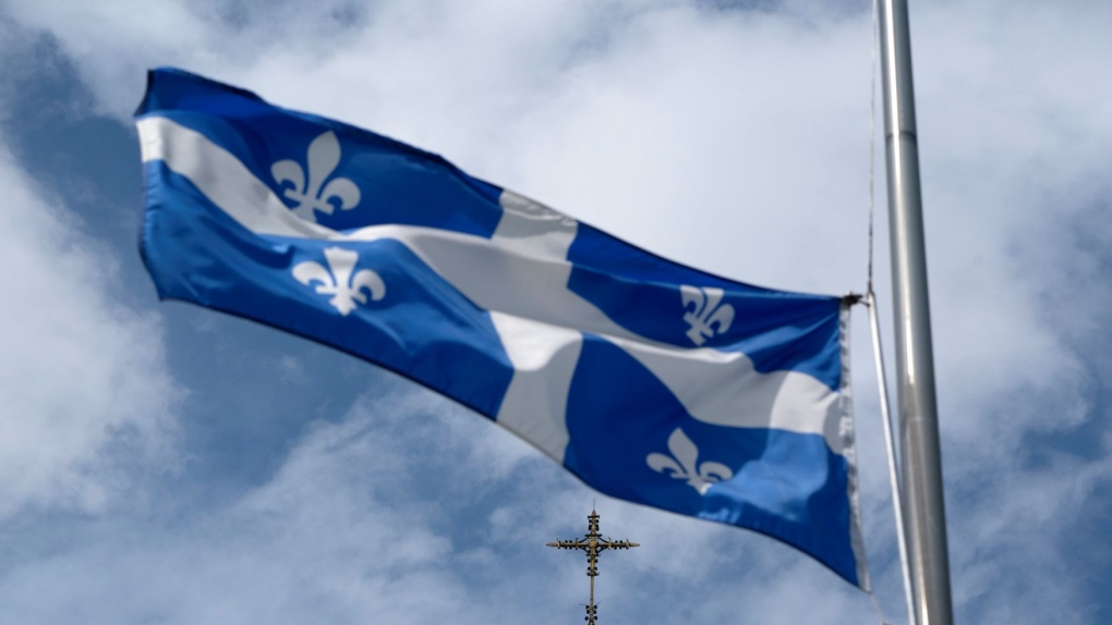 The Quebec flag flies on a flag pole near a church, Tuesday, August 16, 2022 in Gatineau, Que. THE CANADIAN PRESS/Adrian Wyld