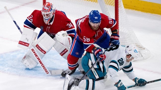 San Jose Sharks' Timo Meier is taken out from in front of Montreal Canadiens goaltender Jake Allen by defenceman David Savard during first period NHL hockey action in Montreal, on Tuesday, November 29, 2022. THE CANADIAN PRESS/Paul Chiasson