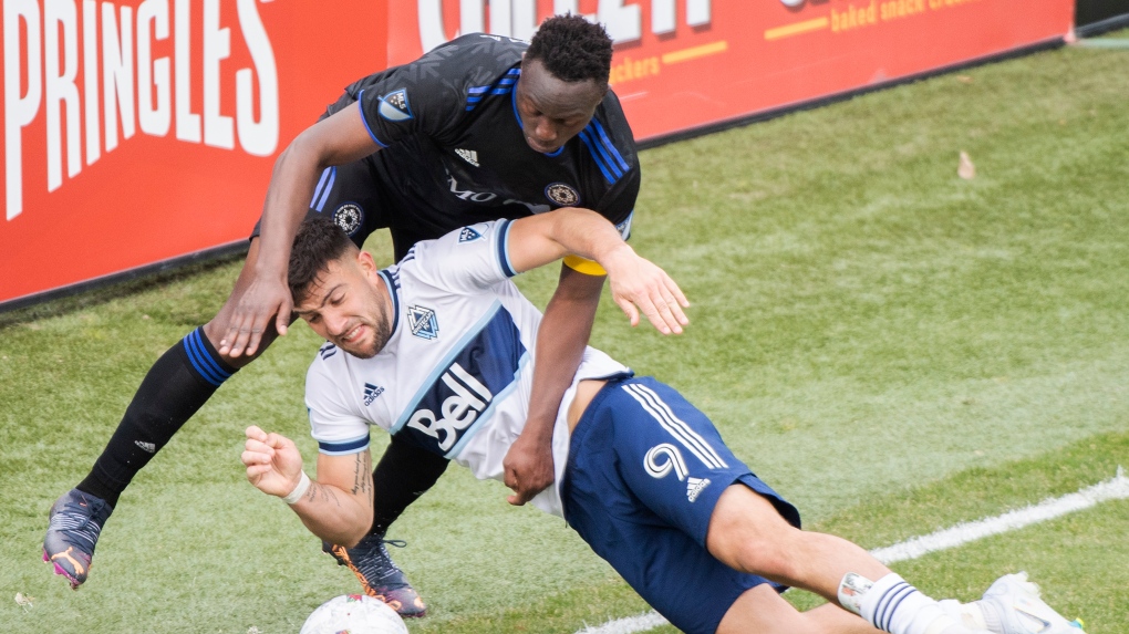 CF Montreal's Victor Wanyama challenges Vancouver Whitecaps' Lucas Cavallini (9) during second half MLS soccer action in Montreal, Saturday, April 16, 2022. THE CANADIAN PRESS/Graham Hughes