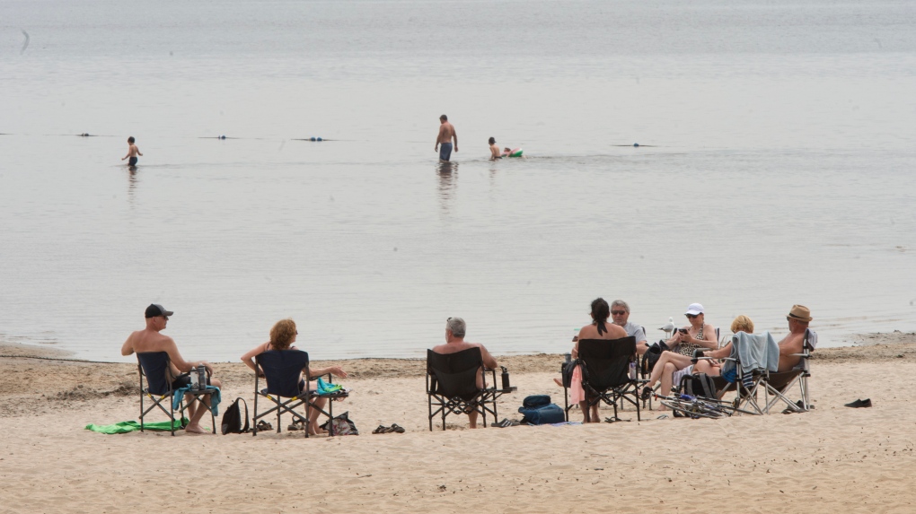 People enjoy the warm weather at the beach in Oka Provincial Park Thursday, May 20, 2021 in Oka, Quebec. The park has limited access after crowds swarmed the beach in the past few days to escape the heat. THE CANADIAN PRESS/Ryan Remiorz