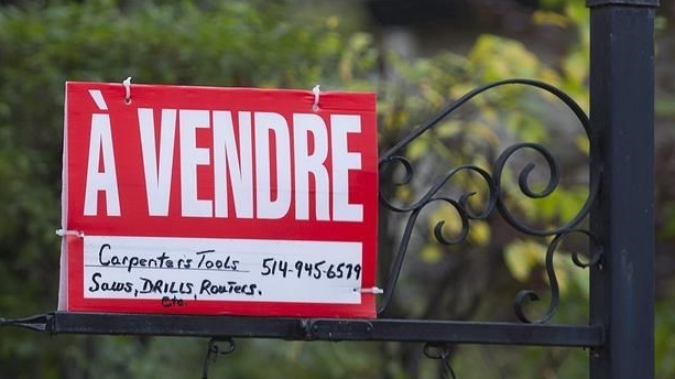 A home for sale sign is shown on the West Island of Montreal, Saturday, November 4, 2017. THE CANADIAN PRESS/Graham Hughes