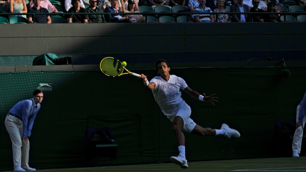 Canada's Felix Auger-Aliassime plays a return to Italy's Matteo Berrettini during the men's singles quarterfinals match on day nine of the Wimbledon Tennis Championships in London, Wednesday, July 7, 2021. (AP Photo/Alastair Grant)