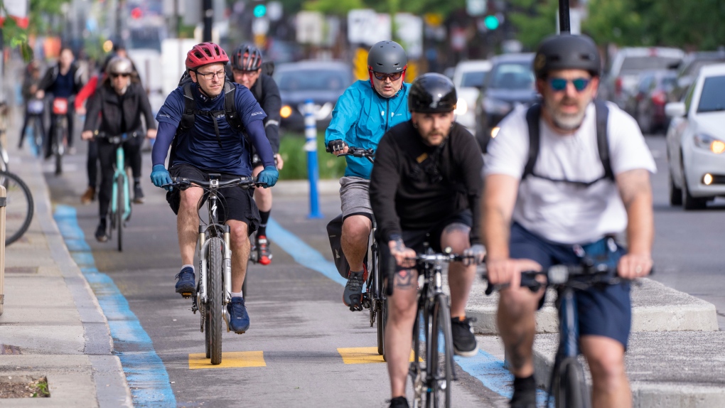 Cyclists make their way down the REV, Reseau Express Velo, on St-Denis street during the morning commute in Montreal on Thursday, June 2, 2022. THE CANADIAN PRESS/Paul Chiasson