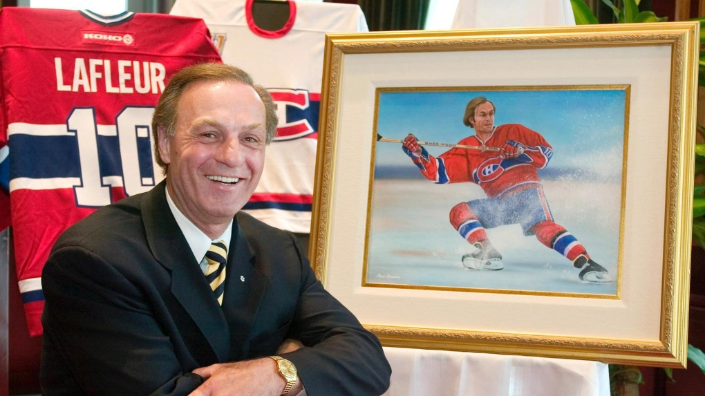 Guy Lafleur poses next to a painting of himself playing hockey by artist Mario Beaudoin on May 18, 2004, in Montreal. -- FILE PHOTO (THE CANADIAN PRESS/Paul Chiasson)