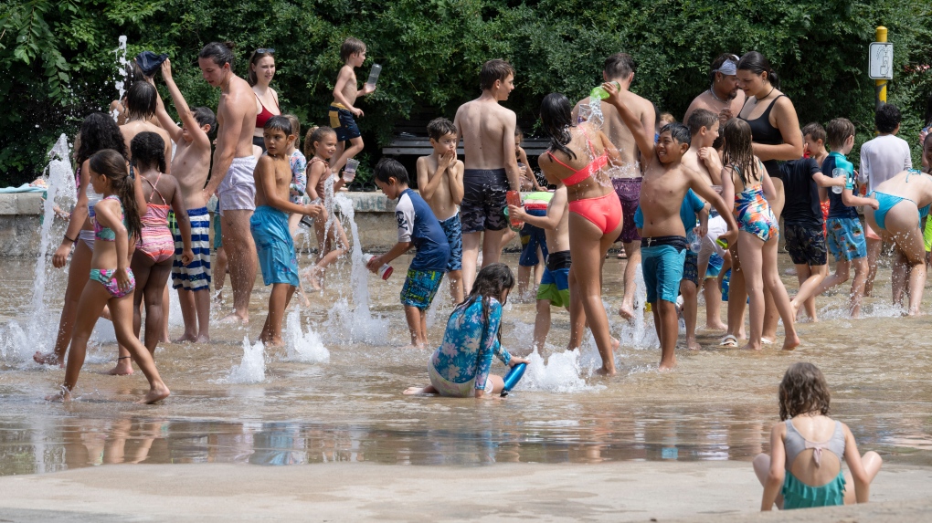 People cool off at a splash pad as temperatures go above 30C in Montreal. (THE CANADIAN PRESS/Ryan Remiorz)
