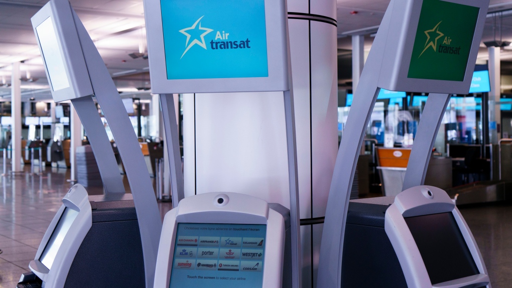 Air Transat self service check-in kiosks are seen at Montreal-Trudeau International Airport in Montreal, on Friday, July 31, 2020. THE CANADIAN PRESS/Paul Chiasson