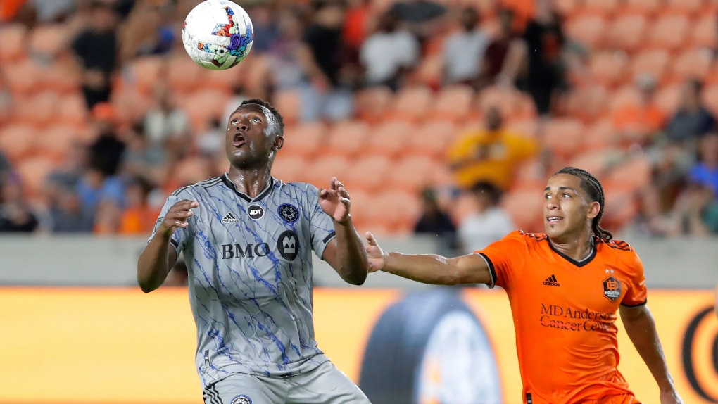 CF Montreal midfielder Victor Wanyama, left, brings down the ball in front of Houston Dynamo midfielder Adalberto Carrasquilla during the second half of an MLS soccer match Saturday, Aug. 13, 2022, in Houston. (AP Photo/Michael Wyke)