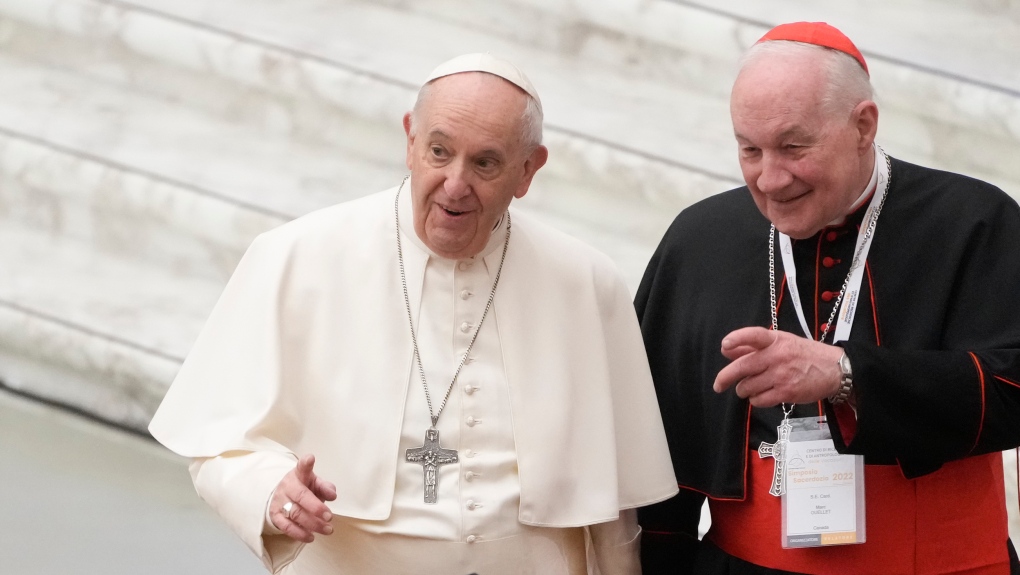 Pope Francis, left, and Cardinal Marc Ouellet arrive at the opening of a 3-day Symposium on Vocations in the Paul VI hall at the Vatican, Thursday, Feb. 17, 2022. (AP Photo/Gregorio Borgia)