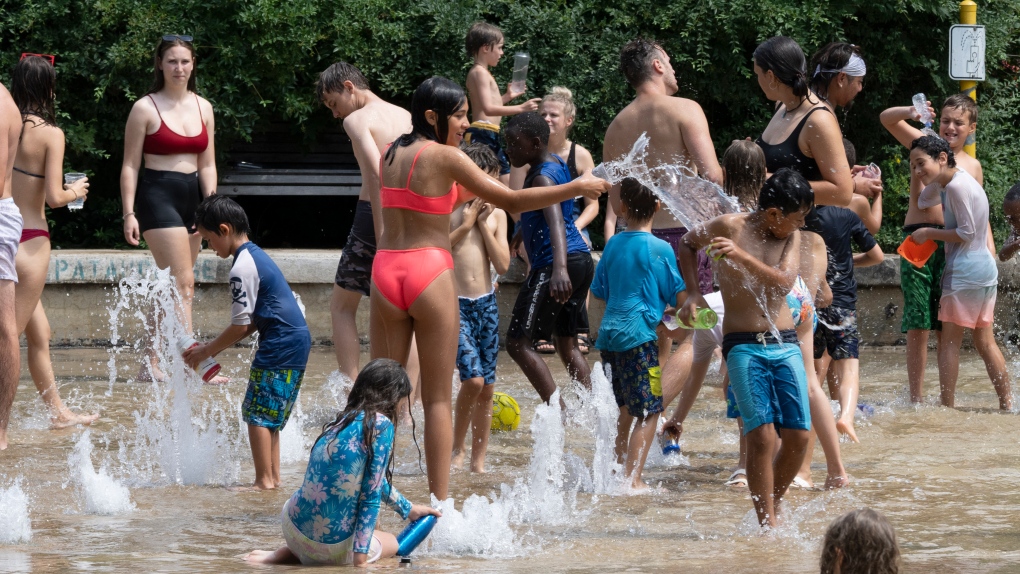 People cool off at a splash pad as temperatures go above 30C, Wednesday, July 20, 2022 in Montreal. THE CANADIAN PRESS/Ryan Remiorz