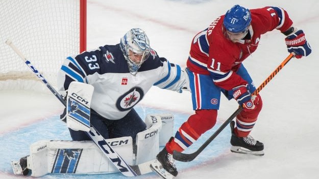Montreal Canadiens’ Brendan Gallagher (11) moves in on Winnipeg Jets goaltender David Rittich during first period NHL pre-season hockey action in Montreal, Thursday, September 29, 2022. THE CANADIAN PRESS/Graham Hughes