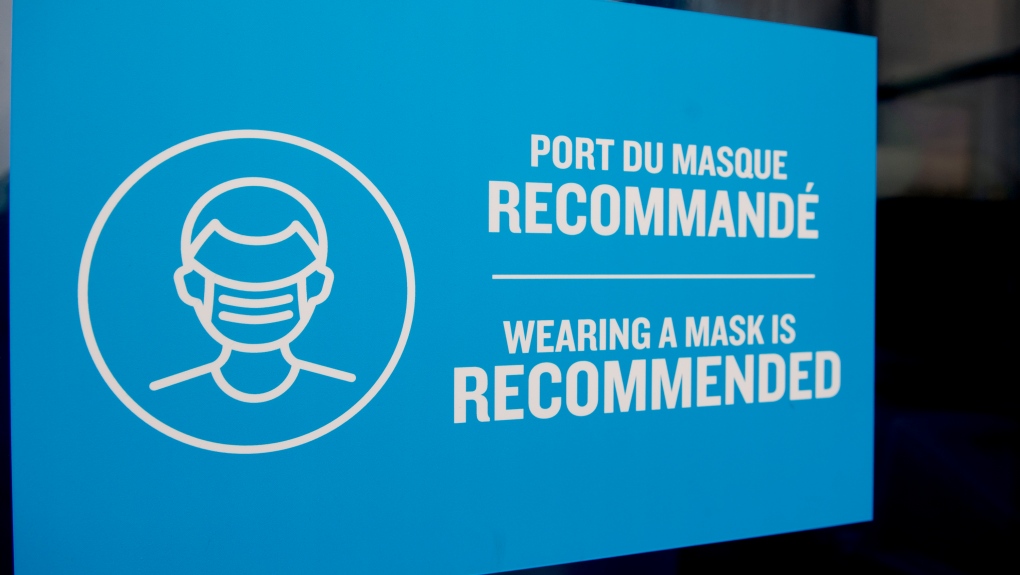 A sign reading wearing a mask is recommended, is shown on a door in Montreal's Old Port, Sunday, January 1, 2023.  (THE CANADIAN PRESS/Graham Hughes)