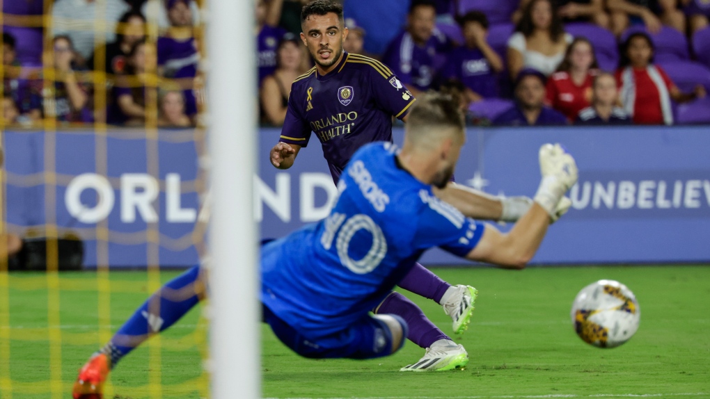 CF Montreal goalkeeper Jonathan Sirois, right, protects the goal against a kick by Orlando City midfielder Martín Ojeda, left, during the second half of an MLS soccer match, Saturday, Sept. 30, 2023, in Orlando, Fla. (AP Photo/Kevin Kolczynski)