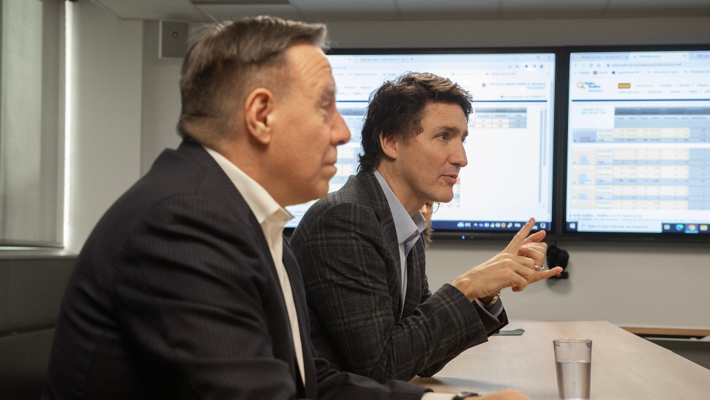 Prime Minister Justin Trudeau, right, and Quebec Premier Francois Legault attend a briefing at a Hydro Quebec operations centre following an ice storm in Montreal, Thursday, April 6, 2023. THE CANADIAN PRESS/Graham Hughes