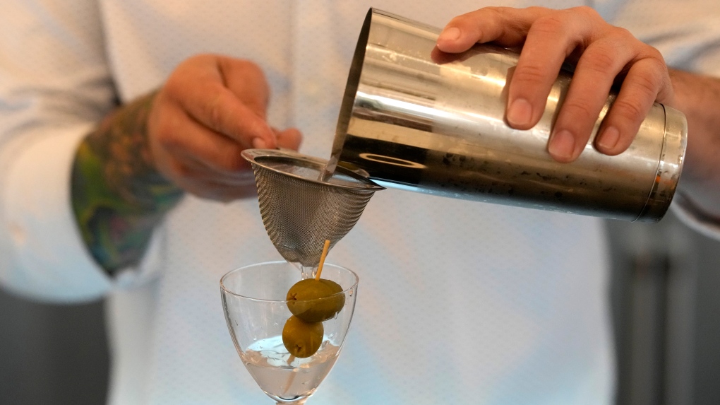 Bartender Brian McGee demonstrates how to make a Dirty Gin Martini with two olives. FILE PHOTO (AP Photo/Charles Rex Arbogast)