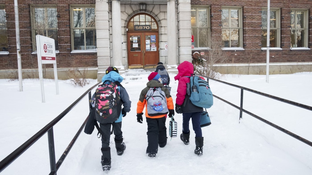 Students arrive at school as Quebec students get back to school in Montreal on Tuesday, January 18, 2022. THE CANADIAN PRESS/Paul Chiasson