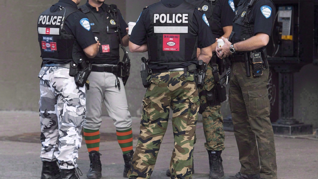 Montreal police officers wore camouflage pants in 2014 during negotiations on their contract. The Surete du Quebec is set to use the same tactic starting Dec. 7, 2023. THE CANADIAN PRESS/Graham Hughes