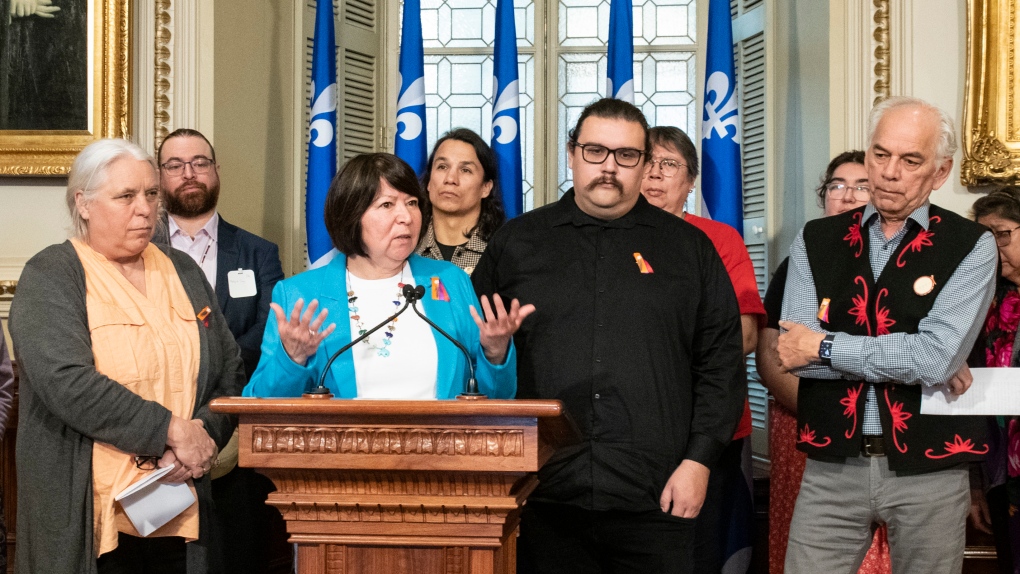 President of QNW Marjolaine Etienne speaks at a news conference after a petition calling on the Quebec government to recognize the existence of systemic racism and discrimination was tabled, at the legislature in Quebec City, Thursday, March 16, 2023. Quebec Solidaire co-spokesperson Manon Masse, far left, and Chief of the AFNQL, Ghislain Picard, far right, look on. THE CANADIAN PRESS/Karoline Boucher.