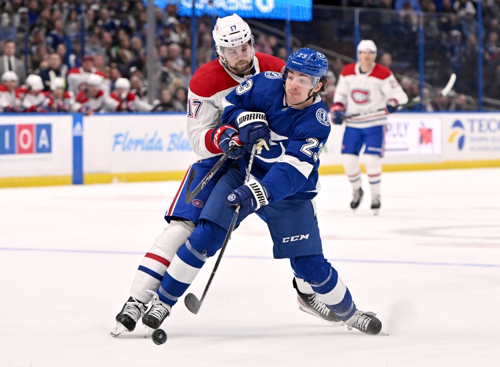 Tampa Bay Lightning center Michael Eyssimont (23) shoots as he is pressured by Montreal Canadiens right wing Josh Anderson (17) during the second period of an NHL hockey game Saturday, March 18, 2023, in Tampa, Fla. (AP Photo/Jason Behnken)