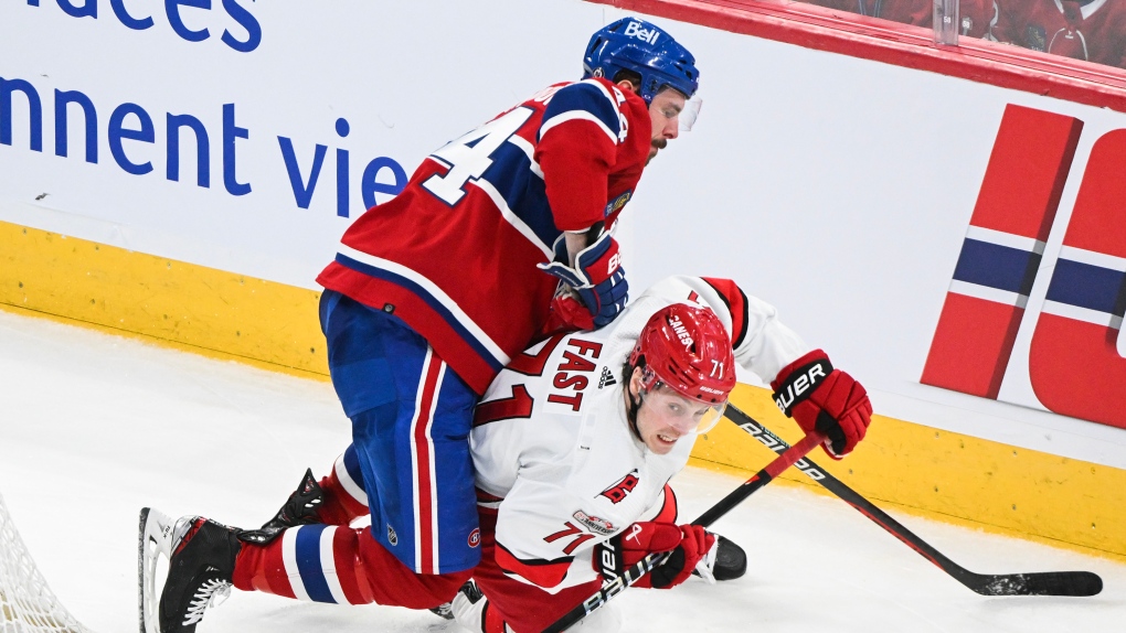 Carolina Hurricanes' Jesper Fast (71) plays a pass as Montreal Canadiens' Joel Edmundson defends during third period NHL hockey action in Montreal, Tuesday, March 7, 2023. THE CANADIAN PRESS/Graham Hughes