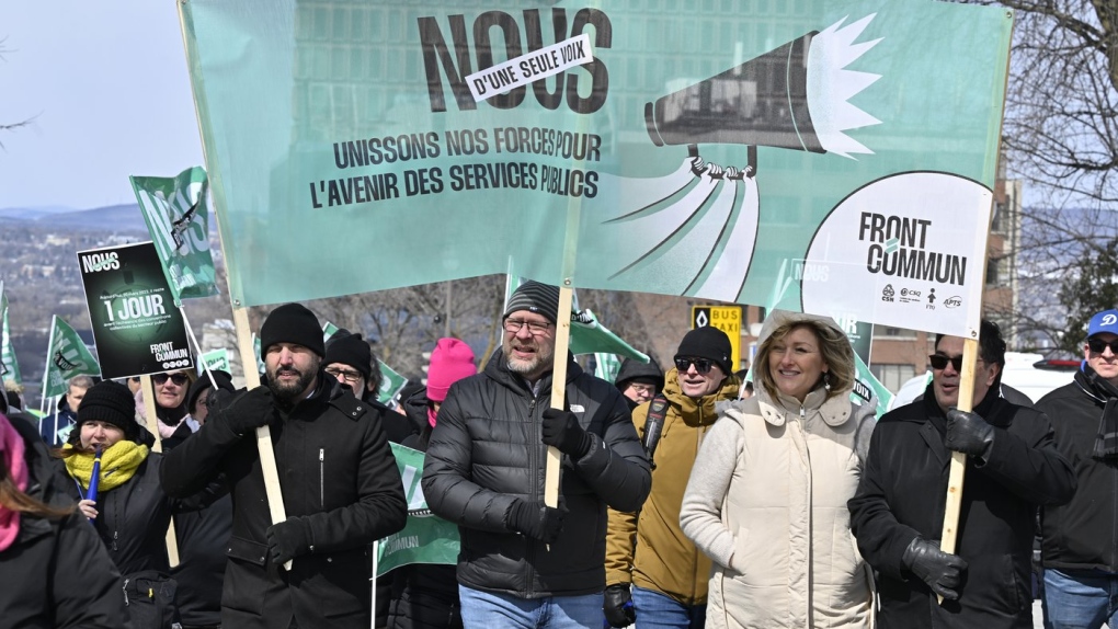 Union leaders Eric Gingras, left to right, CSQ, Robert Comeau, APTS, Magali Picard, FTQ and François Énault, CSN march in a common front on Thursday, March 30, 2023 in front of the legislature in Quebec City. THE CANADIAN PRESS/Jacques Boissinot
