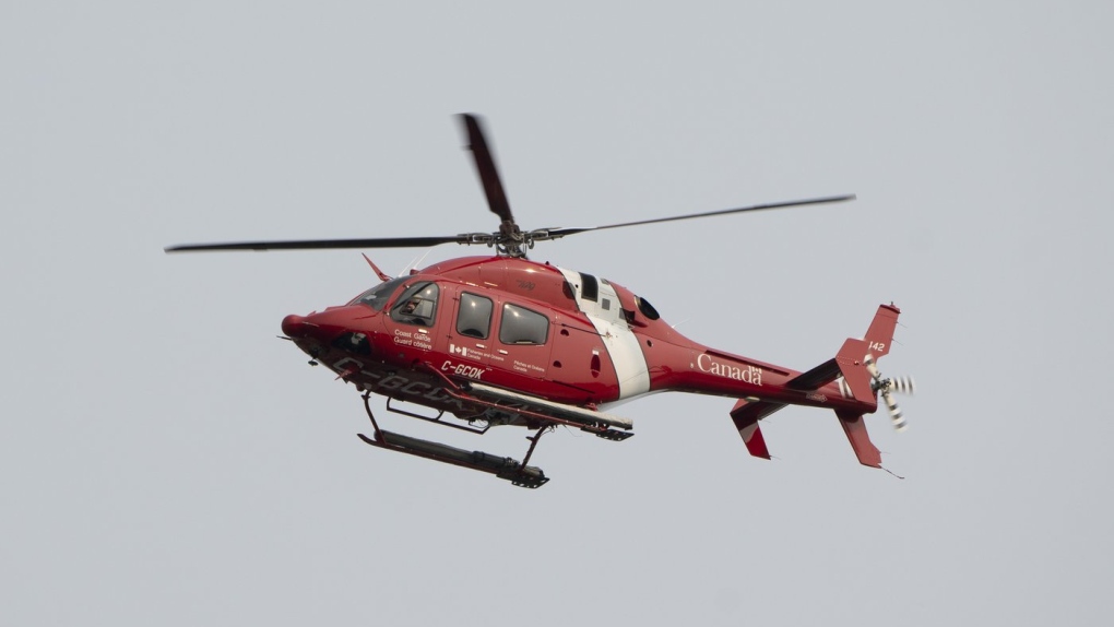 Quebec provincial police say three people are dead after a fishing boat sunk off the province's Lower North Shore.A Coast Guard helicopter flies over the port of St. John’s on Saturday, June 24, 2023. THE CANADIAN PRESS/Adrian Wyld

