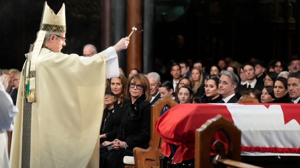 Mila Mulroney and immediate family members look on as Christian Lepine, Archbishop of Montreal, blesses the casket with holy water during the funeral of former prime minister Brian Mulroney, in Montreal, Saturday, March 23, 2024. (Ryan Remiorz, The Canadian Press)