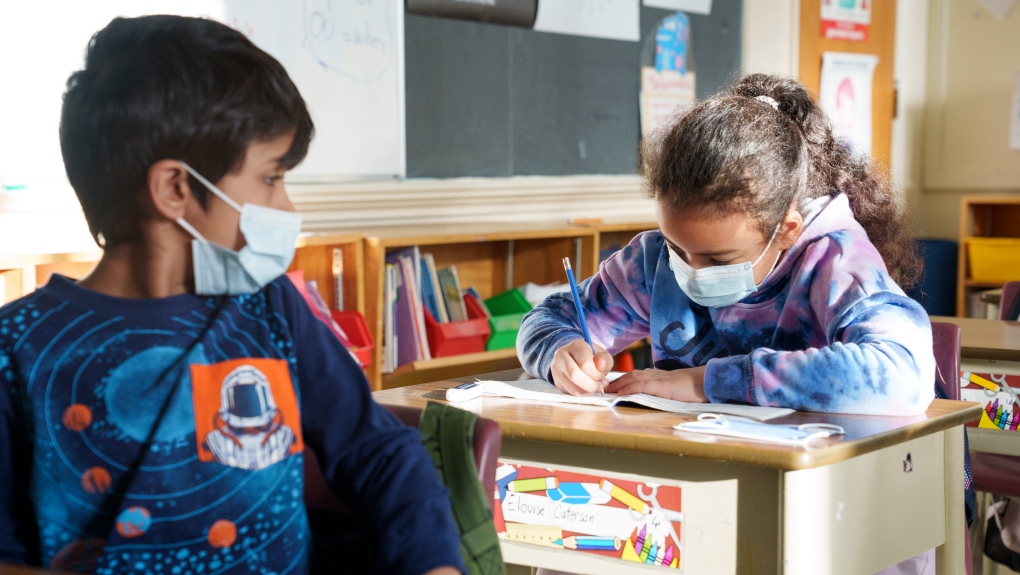 Students in an elementary class get back to work as Quebec students get back to school in Montreal on Tuesday, January 18, 2022. THE CANADIAN PRESS/Paul Chiasson