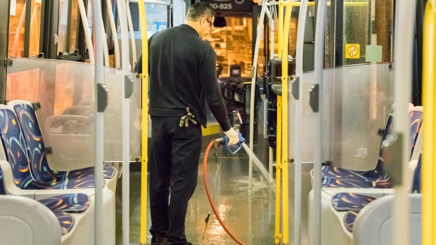 STM staff cleaning a bus